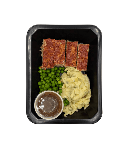 Homestyle meatloaf with smashed potatoes, peas, and beef gravy.